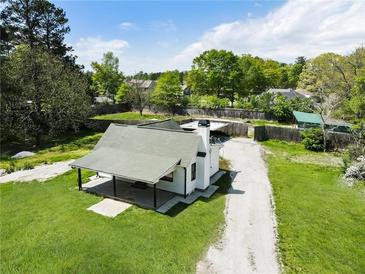 Charming home featuring a spacious yard, covered porch, and a gravel driveway at 3556 Finch Sw Rd, Powder Springs, GA 30127