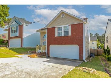 Charming two-story home with red brick accents and an attached one car garage at 3721 Longview Dr, Douglasville, GA 30135