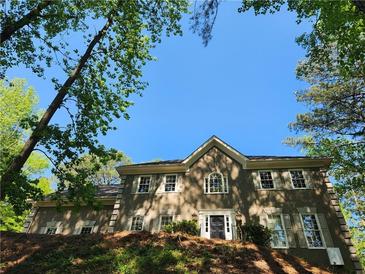 Charming two-story home exterior with beautiful architectural details and manicured landscaping at 7635 Blandford Pl, Atlanta, GA 30350