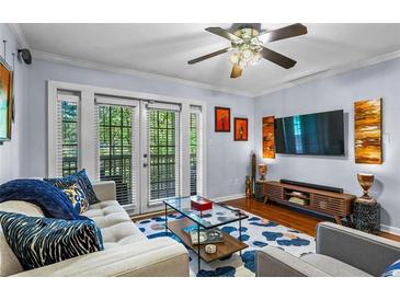 Bright living room features a ceiling fan, modern furniture, and a sliding door at 1445 Monroe Ne Dr # E25, Atlanta, GA 30324