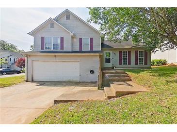 Charming two-story home featuring a garage and inviting front steps leading to the front door at 3311 Basking Shade Ln, Decatur, GA 30034
