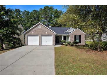 Charming single-story brick home with a well-manicured lawn and a two-car garage at 210 Arbor Creek Dr, Dallas, GA 30157