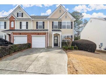 Charming townhouse with two-car garage, manicured landscaping, and inviting front entrance at 3723 Verde Glen Ln, Cumming, GA 30040