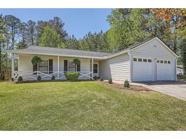 Charming one-story home with a well-manicured lawn and attached two-car garage at 2939 Owens Point Nw Trl, Kennesaw, GA 30152