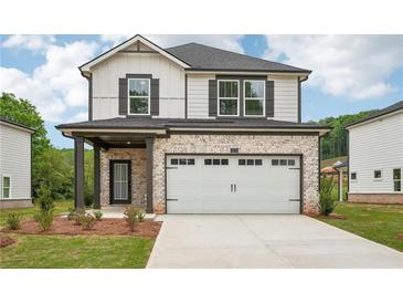 New construction home features a two-car garage and a combination brick and siding facade at 4830 Marjorie Dr, Cumming, GA 30041