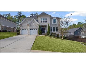 Stunning two-story home featuring a lush green lawn, a concrete driveway, and a two-car garage at 5153 Elkins Ln, Acworth, GA 30101