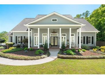 Charming home featuring a grand front porch with stately columns and manicured landscaping at 88 Cline Smith Ne Rd, Cartersville, GA 30121