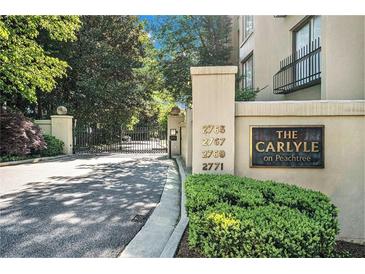 Elegant gated entrance to The Carlyle on Peachtree, with manicured landscaping at 2769 Peachtree Ne Rd # 6, Atlanta, GA 30305
