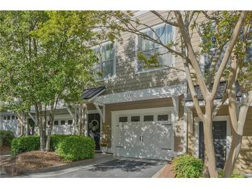 Charming townhome showcasing a well-maintained exterior, front yard, and private garage at 1971 Sterling Oaks Cir, Brookhaven, GA 30319