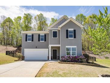 Charming two-story home featuring a gray exterior and well-maintained landscaping at 4740 Alford Commons, Cumming, GA 30028