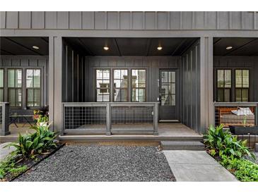 Exterior view of townhomes with private front porches and landscaping at 913 Spencer Ave, Atlanta, GA 30318