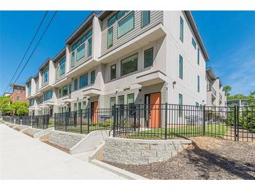 Modern townhomes showcasing clean architectural lines, large windows, and fenced front yards at 1300 Memorial Se Dr # 12, Atlanta, GA 30317