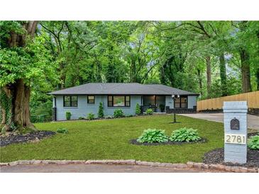 Charming home with mature trees, freshly cut lawn, and updated landscaping at 2781 Long Way, Decatur, GA 30032