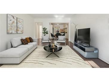 Bright living room with large windows, comfortable seating, and hardwood floors at 55 Delmont Ne Dr # D1, Atlanta, GA 30305