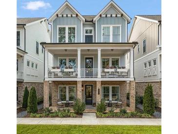Charming home featuring a double-decker front porch with brick foundation and stylish curb appeal at 1004 Baldwin Dr, Milton, GA 30009