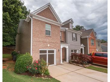 Charming brick front home with attached garage, landscaped yard and a traditional architectural design at 5260 Sherwood Way, Cumming, GA 30040