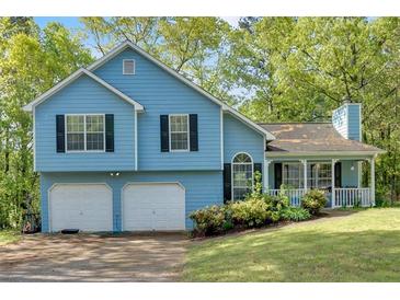 Charming two-story home with a two-car garage and a manicured lawn at 111 Amberwood Ln, Euharlee, GA 30145
