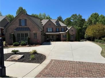 Beautiful brick home with an expansive driveway and well-maintained landscaping at 187 Slate Dr, Buford, GA 30518
