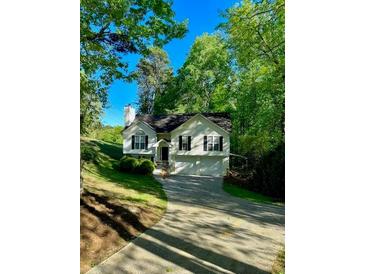 Two-story home featuring mature trees and a well-maintained yard at 2180 Ridge Rd, Canton, GA 30114