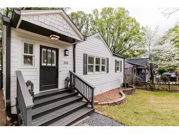 Charming home featuring a black front door, gray stairs, and decorative lanterns at 308 Greenwood Ave, Decatur, GA 30030