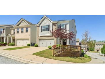 Charming home featuring a two-car garage, manicured lawn, and welcoming curb appeal at 815 Regal Sw Ln, Atlanta, GA 30331