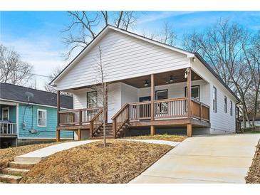 Charming bungalow-style house with a welcoming front porch and modern design elements at 907 Oakhill Sw Ave, Atlanta, GA 30310