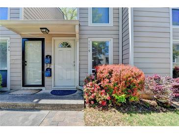 Charming front entrance with a beautiful flower bush and well-maintained landscape at 1119 Riverbend Club Se Dr, Atlanta, GA 30339
