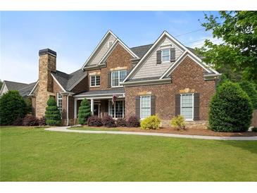 Charming two-story brick home with a manicured front lawn and a stone chimney at 416 Battlefield Creek Dr, Marietta, GA 30064