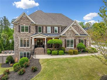 Charming brick home with manicured lawn and stately curb appeal, perfect for luxurious living at 903 Shaftoe Nw St, Kennesaw, GA 30152