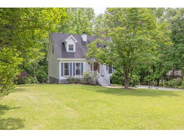 Charming two-story home with a lush green lawn and mature trees at 2009 Shipwreck Ct, Buford, GA 30518
