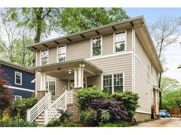 Charming two-story home featuring a cozy front porch and a well-manicured front yard at 286 Norwood Ne Ave, Atlanta, GA 30317
