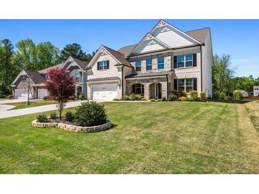 Two-story home boasts a brick and siding facade, a well-manicured lawn, and an attached two-car garage at 4188 Fawn Ivy Ln, Marietta, GA 30064