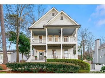 Charming two-story home featuring double porches, a welcoming facade, and manicured landscaping at 2580 Defoors Ferry Nw Rd, Atlanta, GA 30318