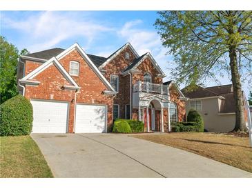 Beautiful two-story brick home with a two car garage and well maintained lawn at 1410 White Flowers Ln, Lawrenceville, GA 30045