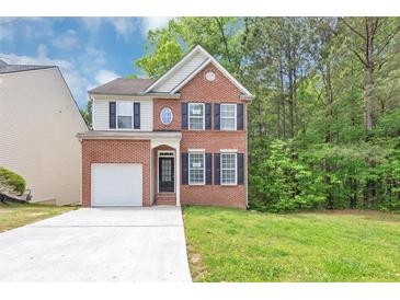 Charming two-story brick home with a well-maintained lawn and attached garage at 6252 Shenfield Ln, Union City, GA 30291