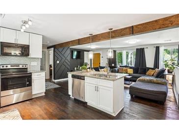 Open concept kitchen with stainless steel appliances and granite countertops at 877 Lee Andrews Se Ave, Atlanta, GA 30315