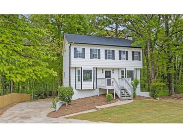 Charming two-story home with a well-maintained front yard and lush landscaping at 3905 Mill Glen Dr, Douglasville, GA 30135