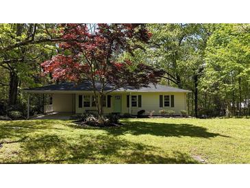 Charming home with a well-manicured front yard and lush greenery at 343 Ridge Pine Dr, Canton, GA 30114