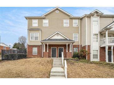 Inviting two-story townhouse with charming brick accents and well-maintained lawn at 277 Ralph David Abernathy Blvd, Atlanta, GA 30312