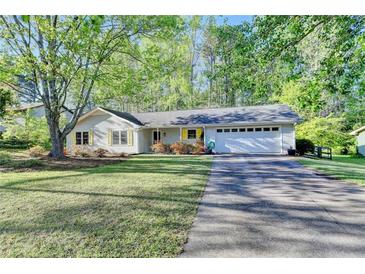 Charming ranch-style home featuring a well-maintained front yard, driveway, and two-car garage at 1132 Owen Cir, Sugar Hill, GA 30518