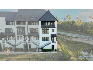 Beautiful, modern townhouse with white and black accents and a balcony overlooking the street at 6666 Sterling Dr, Sandy Springs, GA 30328