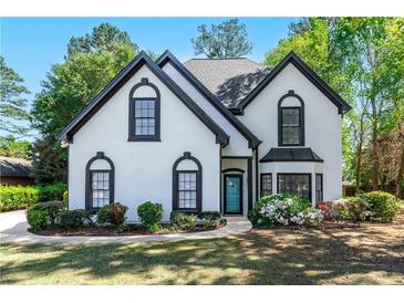 Charming two-story home featuring a well-manicured lawn and beautiful landscaping around the front of the house at 4161 Sherwood Oaks Dr, Decatur, GA 30034