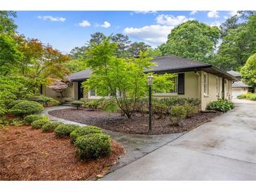 Charming home with a landscaped front yard featuring lush greenery and a stone pathway at 705 W Ponce De Leon Ave, Decatur, GA 30030