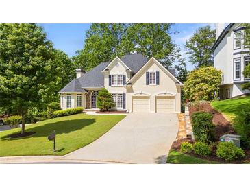 Charming two-story home featuring a manicured front lawn and a two-car garage at 3105 Birchton St, Johns Creek, GA 30022