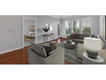 Bright living room with large windows, hardwood floors, and stylish furnishings perfect for relaxing or entertaining guests at 1850 Cotillion Dr # 4204, Dunwoody, GA 30338
