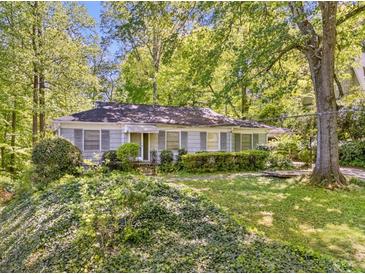 Charming single-story home with a lush front yard, mature trees, and neutral siding at 1715 E Clifton Ne Rd, Atlanta, GA 30307