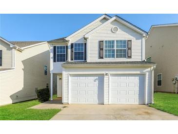 Charming two-story home featuring a two-car garage and well-maintained lawn at 7503 Garnet Dr, Jonesboro, GA 30236
