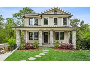 Charming two-story home with stone accents, a manicured lawn, and a welcoming front porch at 2193 Virginia Ne Pl, Atlanta, GA 30305