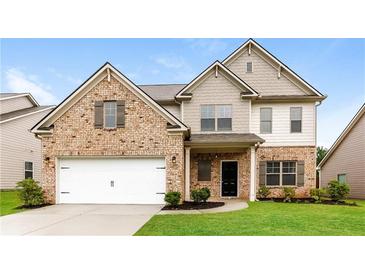 Charming two-story home with brick and siding exterior, attached garage, and well-manicured lawn at 3200 Camden Ct, Atlanta, GA 30349