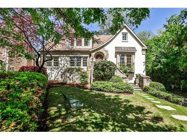 Charming home with a landscaped front yard, stone walkway, and architectural details at 272 Rumson Ne Rd, Atlanta, GA 30305